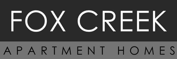 A sign that says "Fox Creek Apartment Homes".